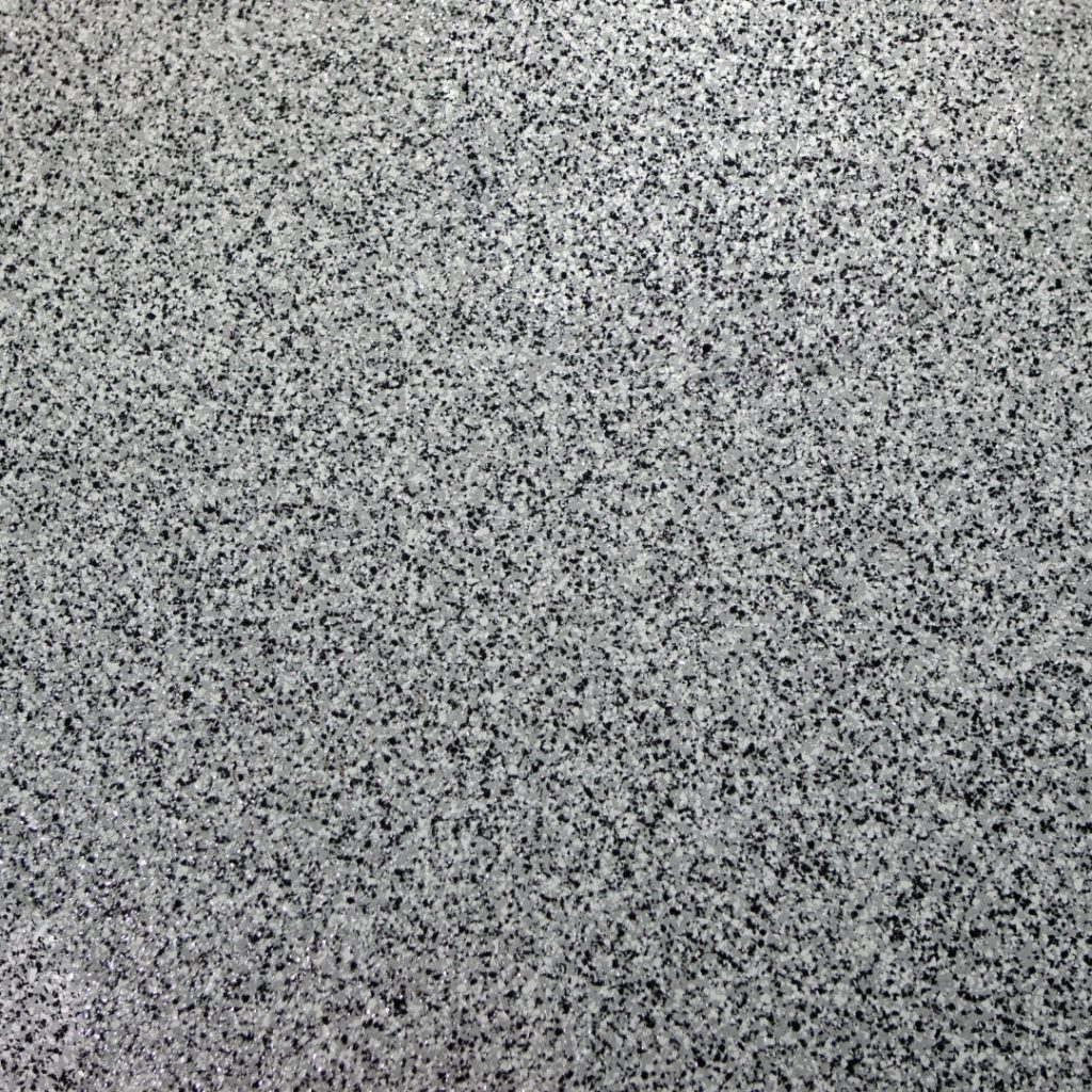 This epoxy flooring, featuring stylish black speckles, exemplifies decorative epoxy solutions that enhance and elevate interior spaces with a modern and elegant touch. Ideal for adding a unique design element to any room.