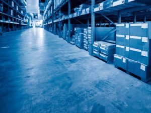 Warehouse with epoxy floor showing signs of epoxy floor scratches along the surface, highlighting wear and tear.