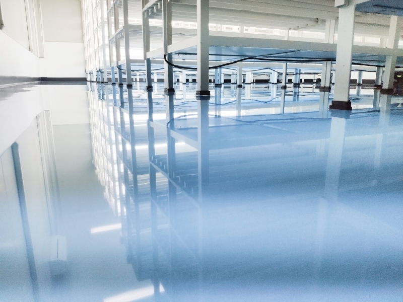 Reflective surface showcasing the benefits of epoxy coating types for industrial and commercial spaces.