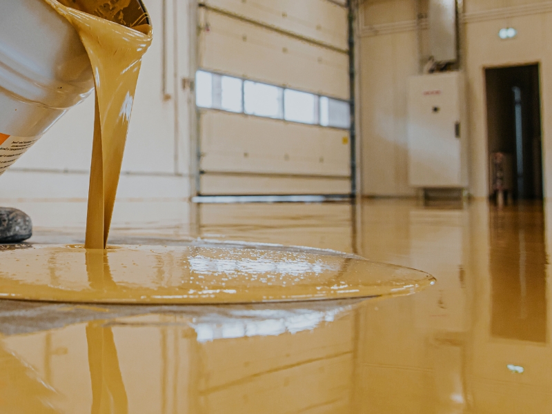 Applying a smooth coat of the best epoxy floor paint for a durable, long-lasting finish.