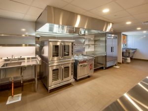 A modern kitchen showcasing a tile floor layout, highlighting the potential of epoxy flooring in kitchen designs for durability.