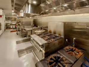 Epoxy flooring in a commercial kitchen, showcasing its durability and easy-to-clean surface.