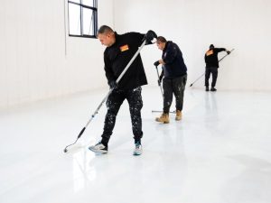 Installing epoxy flooring to fix uneven floors and create a smooth, durable surface in a residential space.